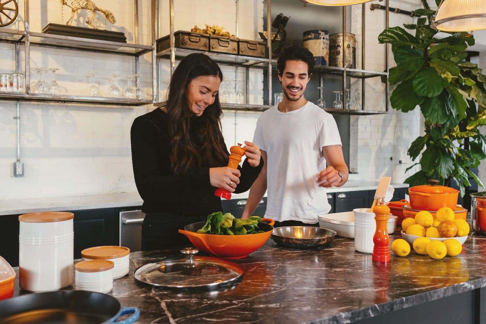 Two people cooking together at a kitchen counter