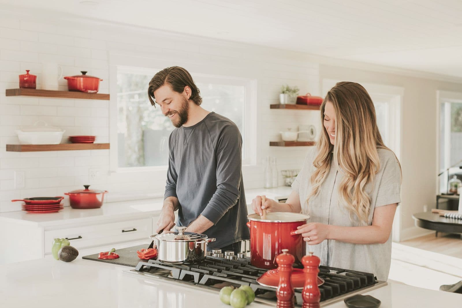 Two people cooking together in a bright kitchen